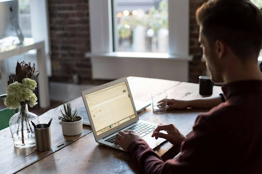 man setting up website on laptop